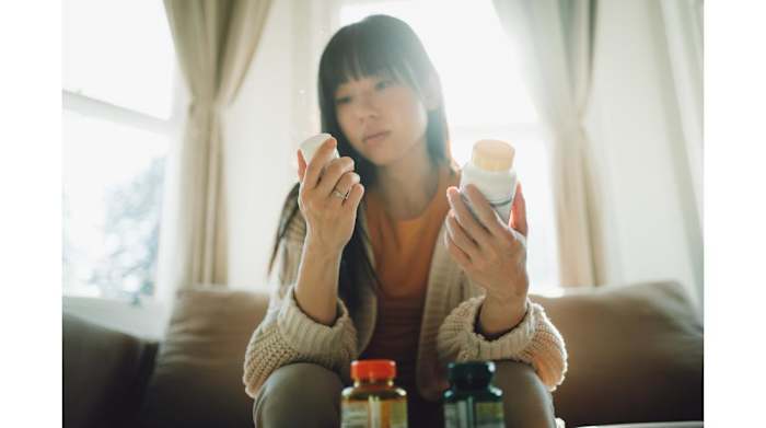 woman-holding-pill-bottles